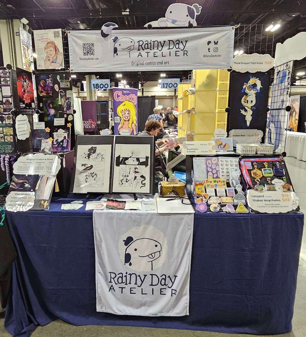 Photo of our table setup at Coastal Comic Con 2025